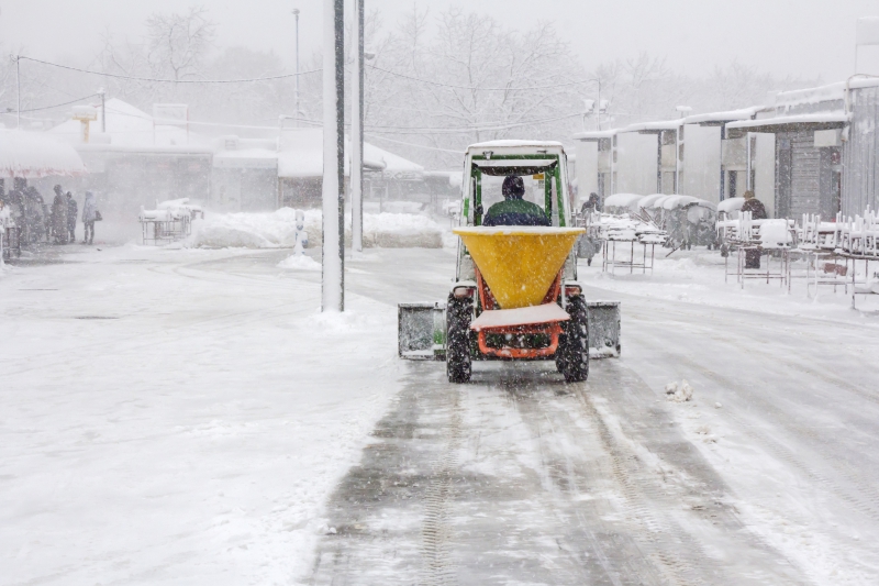 Man using snow and salt cart