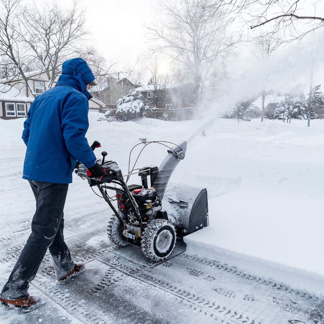 person using a snow blower