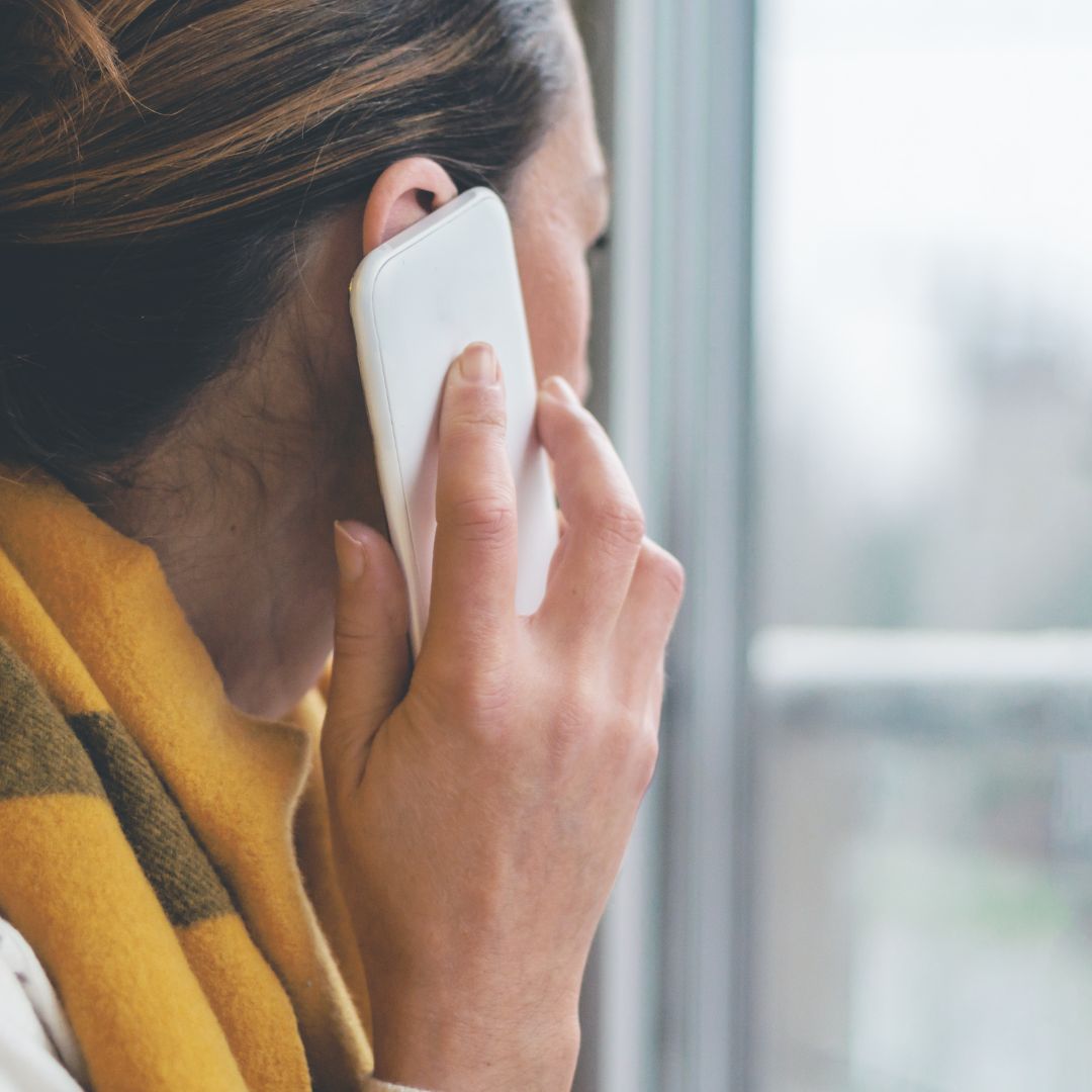 woman in a scarf making a call