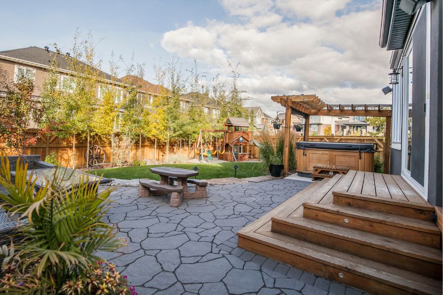 a covered hot tub in a landscaped backyard