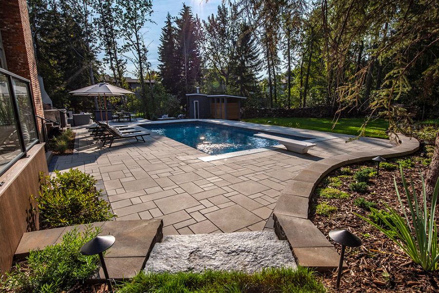 a large patio with seating and a pool