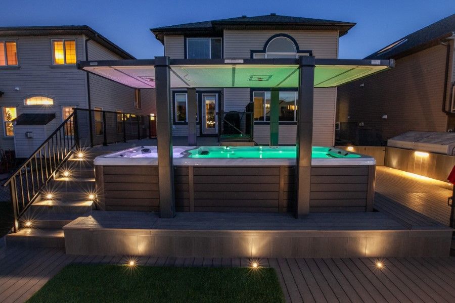 a covered hot tub with multi-colored lights