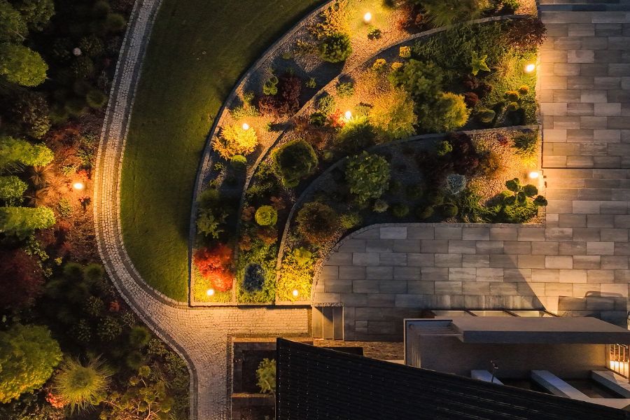 overhead view of landscaped yard with patio and flower beds