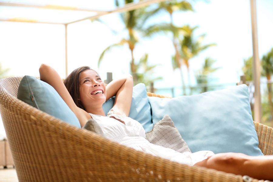 woman lounges in outdoor seating