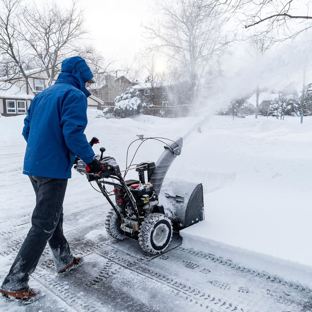 man using snow blower