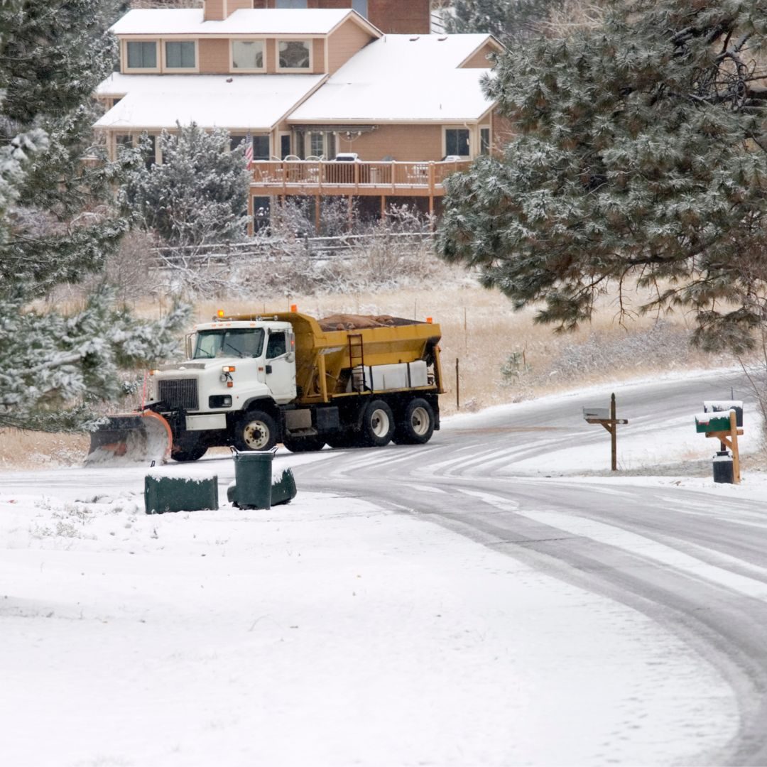 snow plow near residential houses